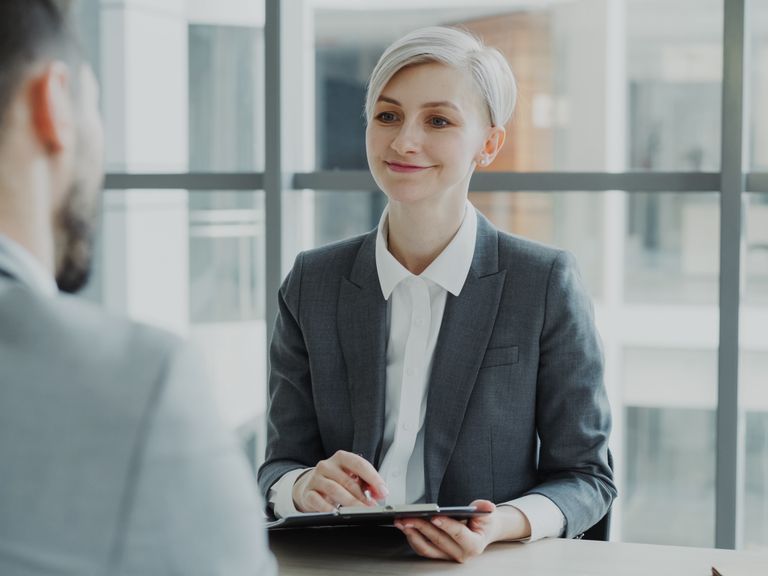 Recruitment consultant interviewing a candidate in an office